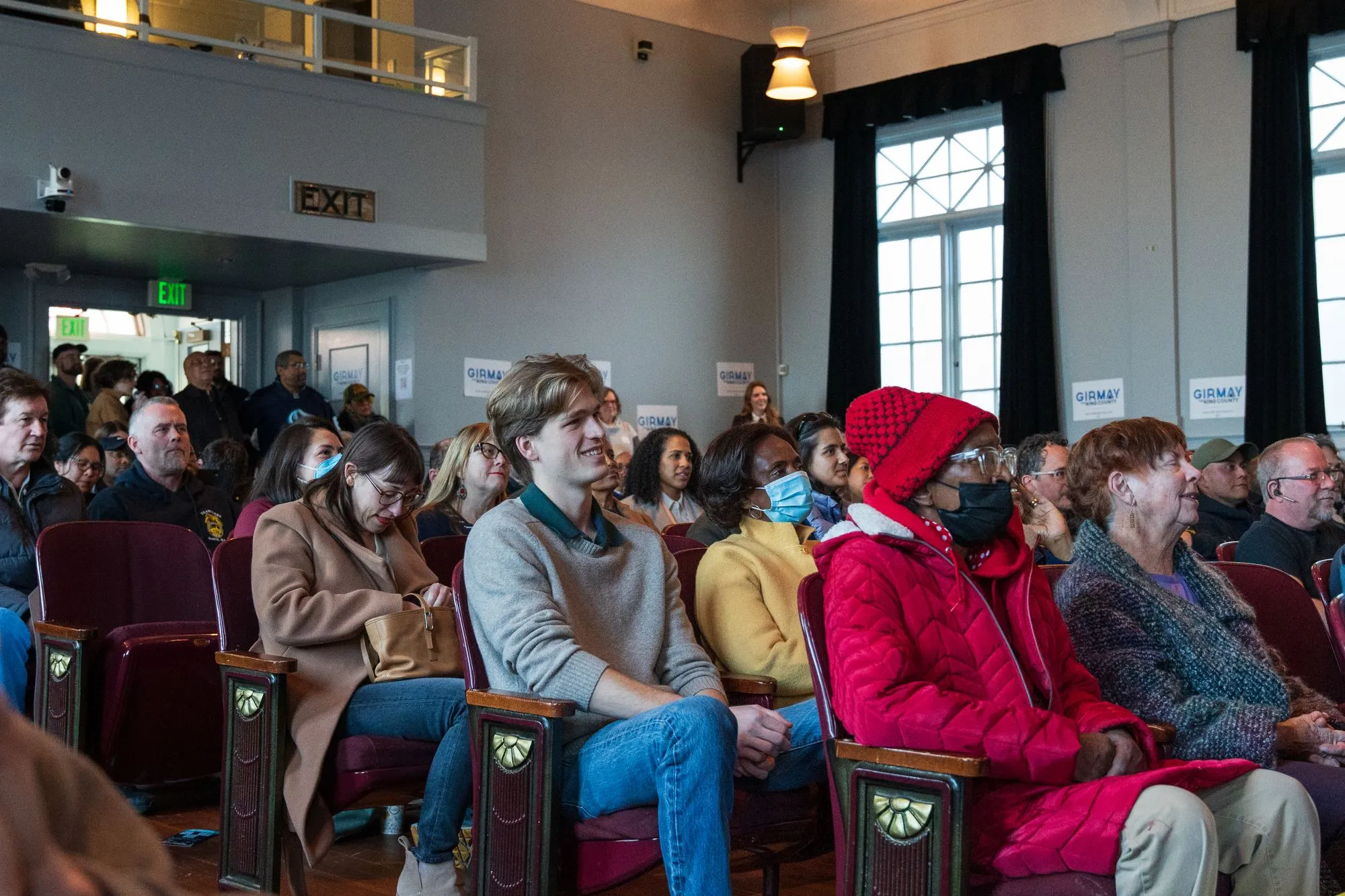 People gathered in discussion at a public meeting.