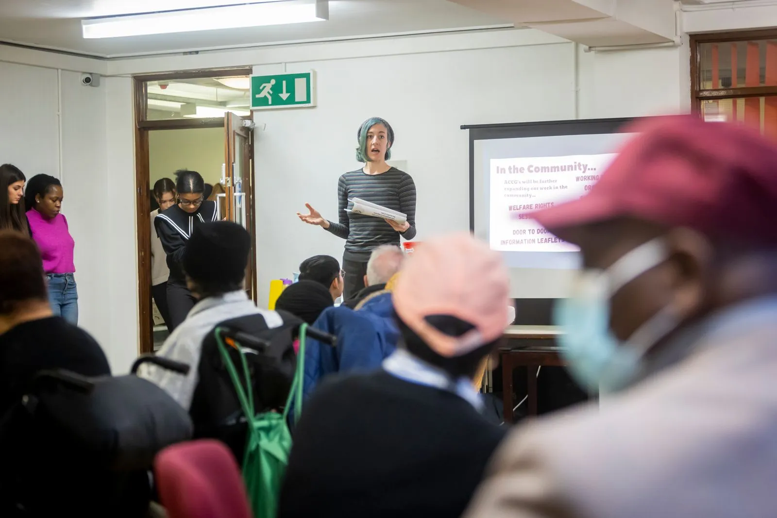 A presenter speaking at a community meeting.