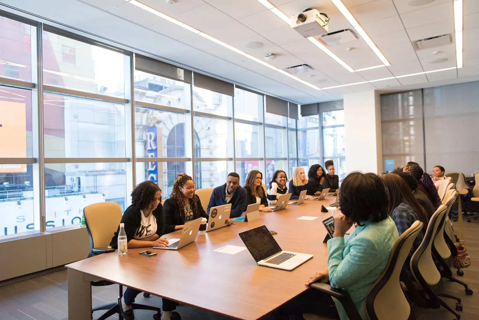 A group meeting around a table in a modern boardroom.