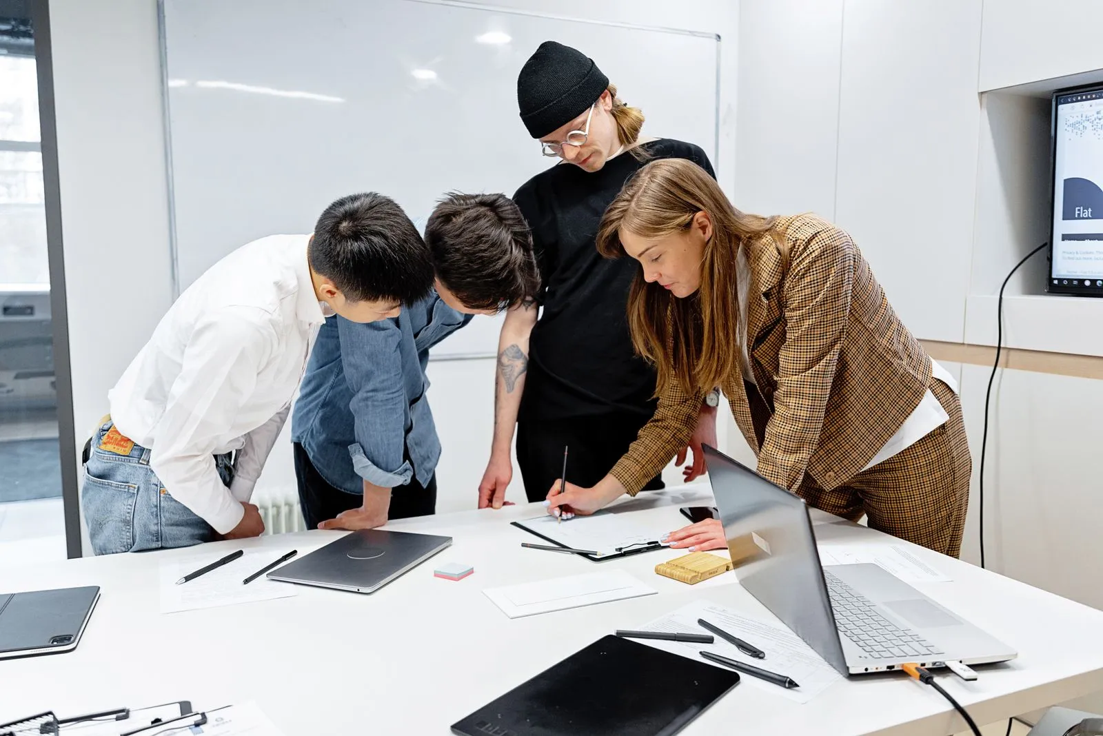 Colleagues collaborating over documents at a table.