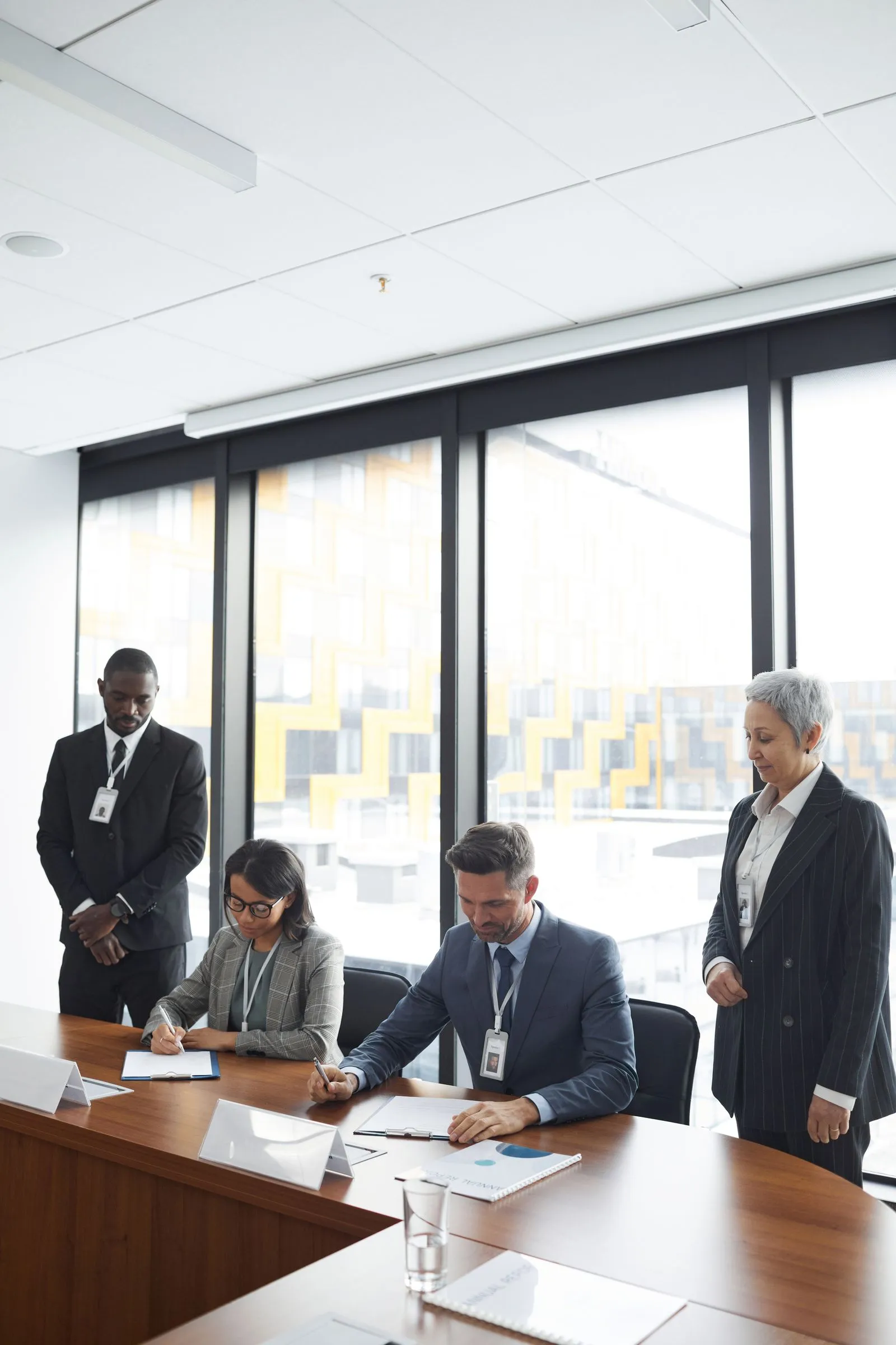 A team signing contracts in a conference room.