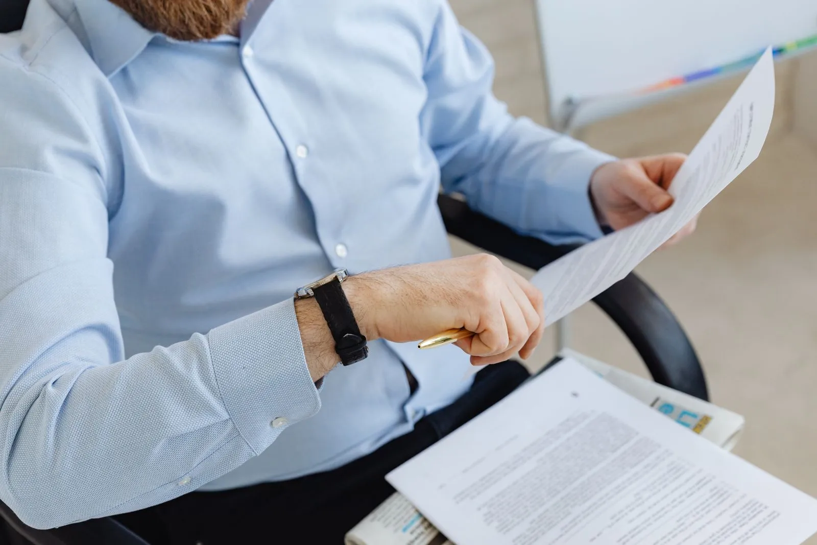 A professional reading a printed document.