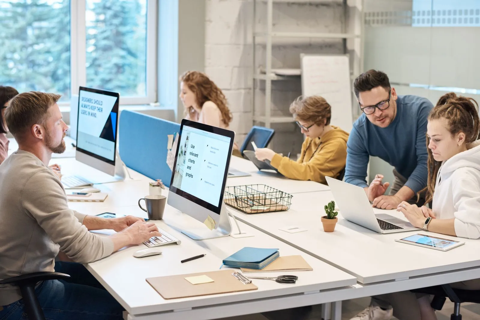 A team working together at computers in an office.