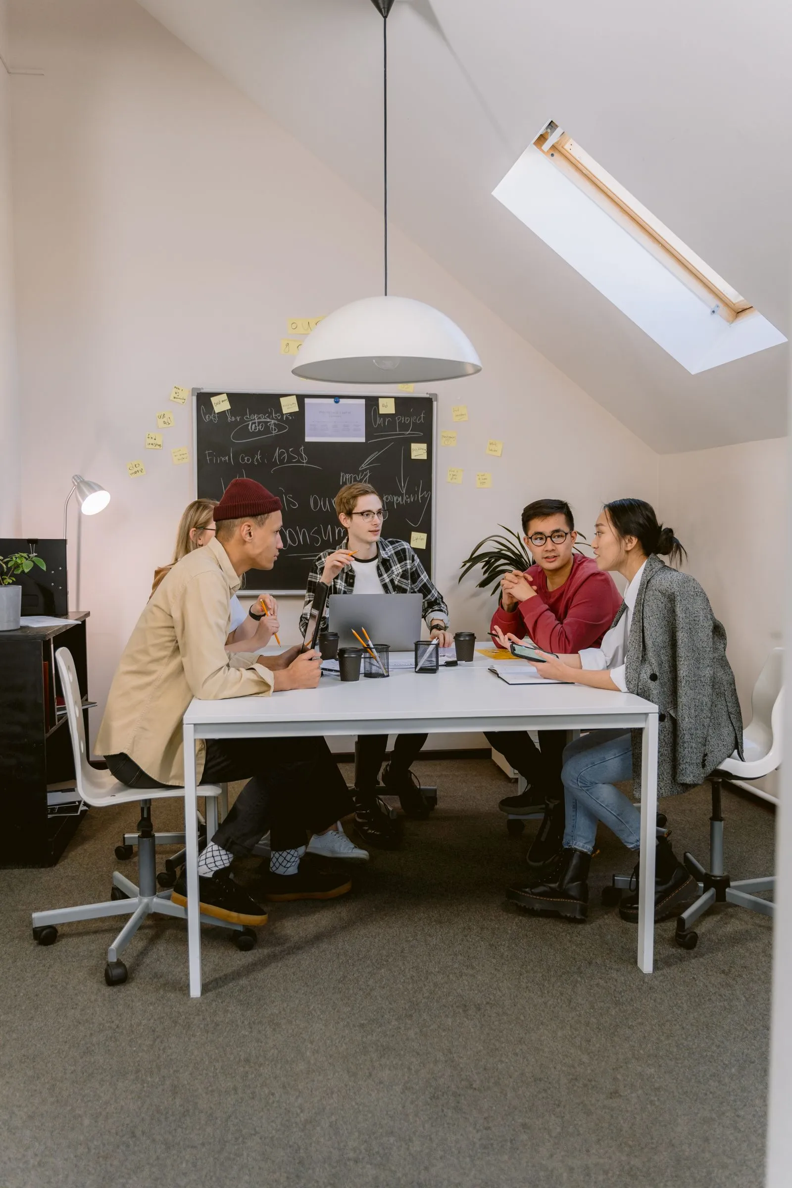 A small team in discussion around a table.