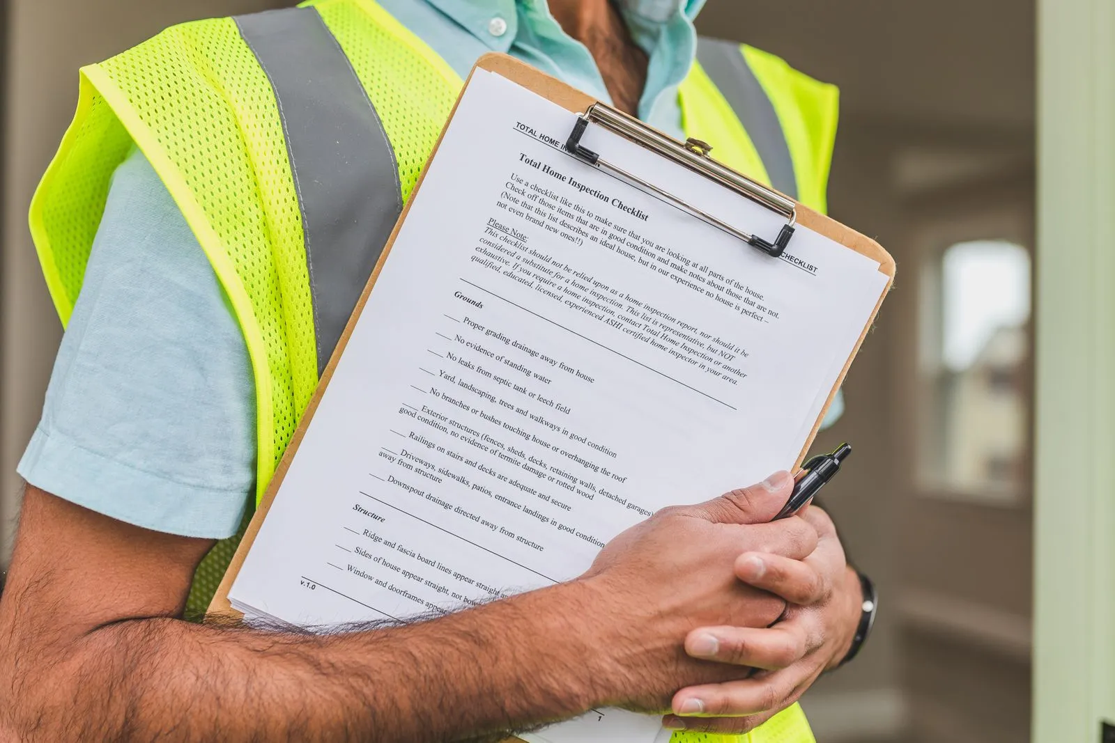 An inspector holding a checklist on a clipboard.